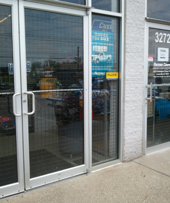 door and storefront secured by wire security panels
