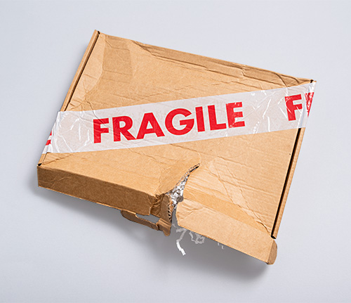 damaged cardboard box with fragile sticker