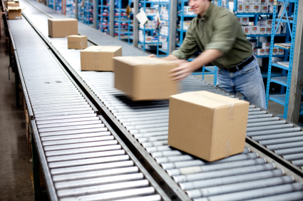 man putting a carton on a moving conveyor line