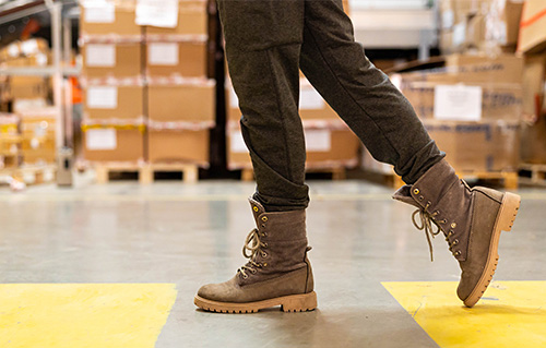 boots walking in a warehouse