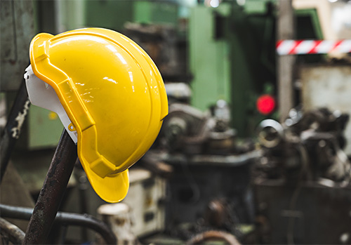 yellow hard hat hanging in an industrial space