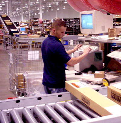 picking from conveyors at a packing station