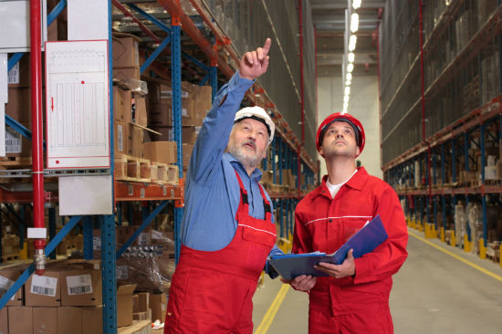 warehouse workers in a rack row