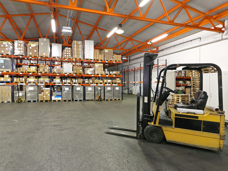 Forklift in front of rack and shelving warehouse system