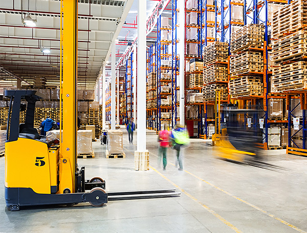 workers walking in a pedestrian lane in a warehouse