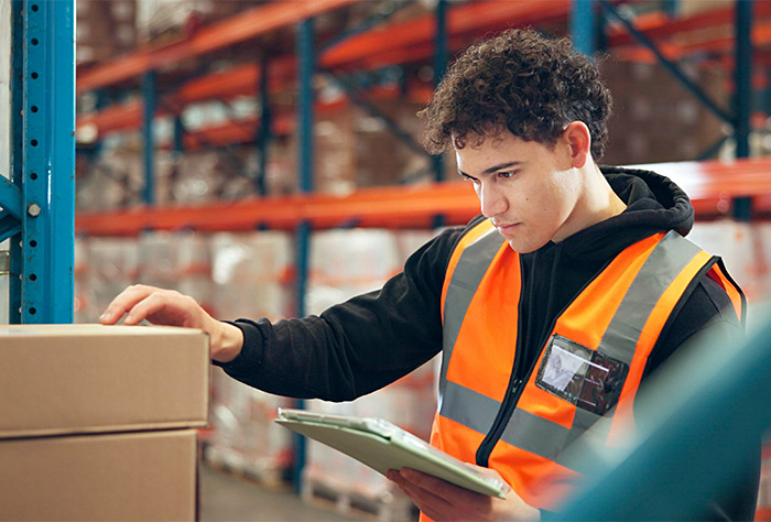 worker selecting box from warehouse rack