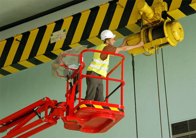 maintenance worker at a factory, working at height