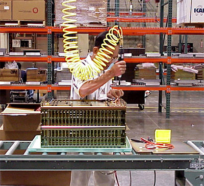 assembly worker using conveyor at working height for ergonomics