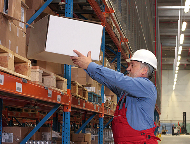 worker removing box from pallet rack