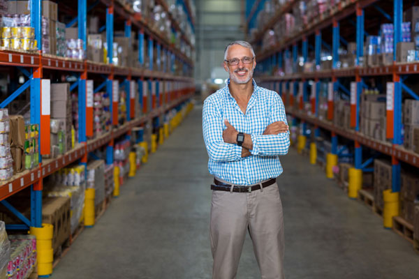 warehouse manager in a pallet rack aisle