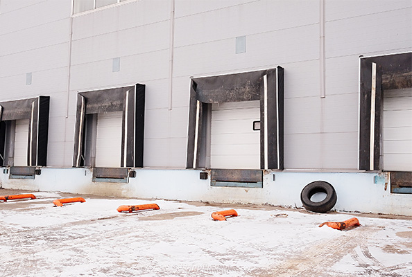 warehouse dock doors with snow on the ground