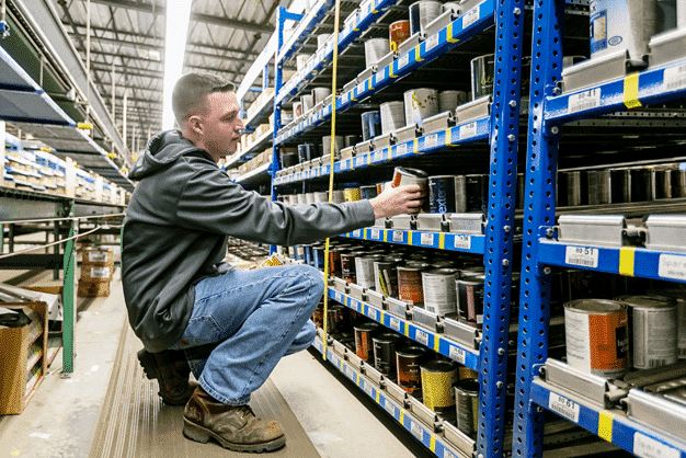 picking cans from a carton flow rack