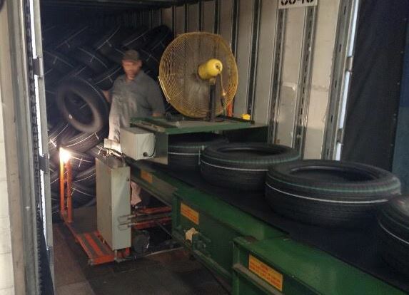 loading tires into a truck trailer with extendable conveyors
