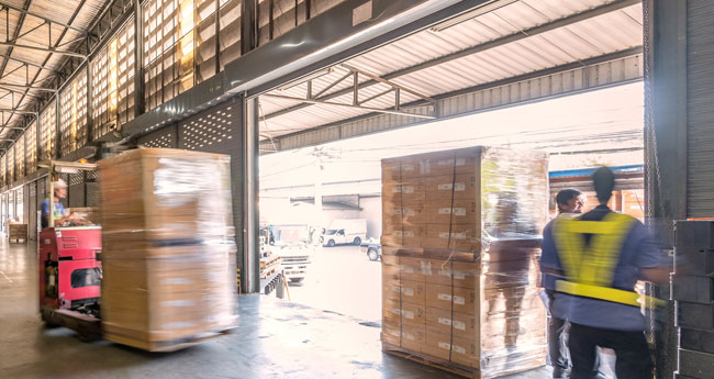 forklifts and pedestrians near a dock door