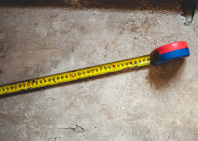 rusty tape measure on concrete floor