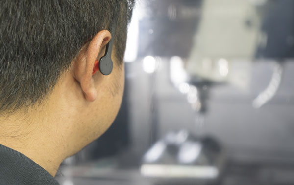 manufacturing worker with earplugs