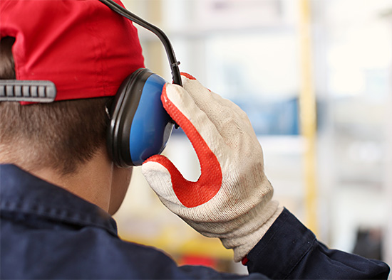 worker putting on ear protection