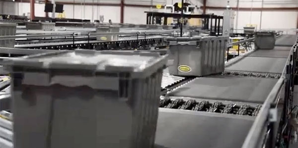 sortation conveyor system moves totes off the line in an automated system