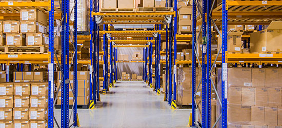 rack tunnel in a distribution warehouse, where forklifts pass through a cross-aisle.