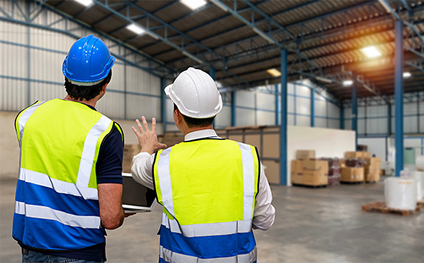 two men in hard hard hats and safety vests