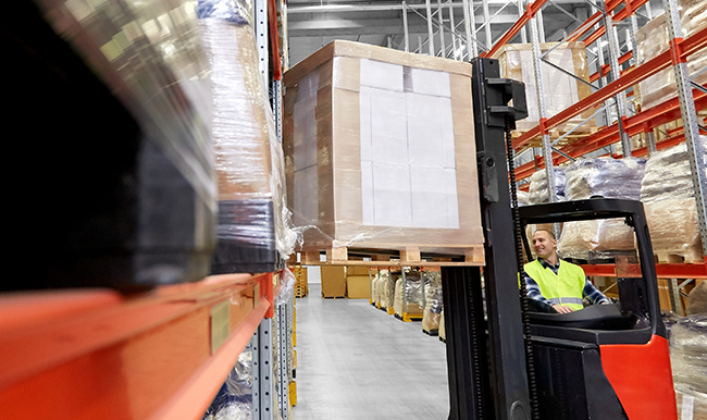 forklift loading pallets in warehouse rack