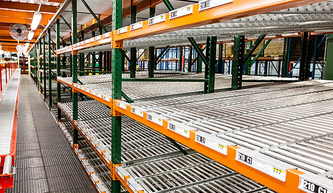 Carton flow tracks set into pallet rack in a distribution center