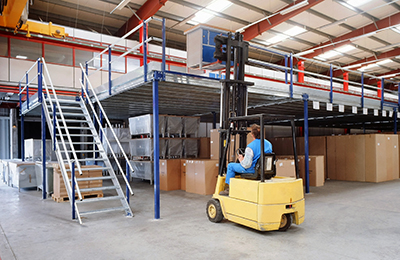 forklift loading a pallet onto a mezzanine platform.