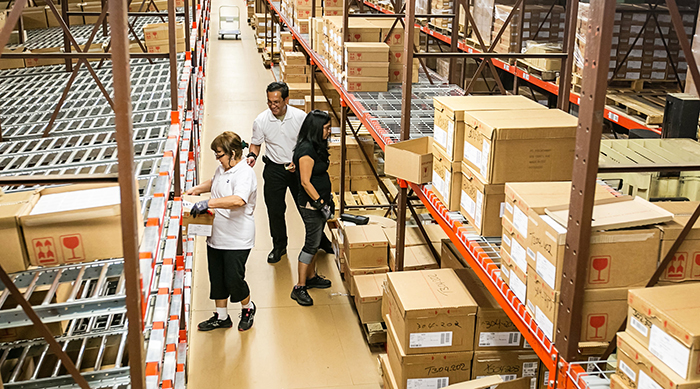 Putaway aisle in a distribution center, with flow storage and bulk storage accessibility.