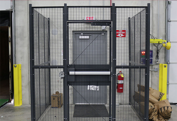 Driver access cage securing a warehouse personnel door.