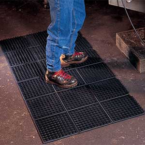 worker standing on floor mat