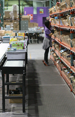 worker picking an order in a pick-to-light system