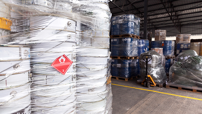 Flammable liquids stacked on a warehouse floor