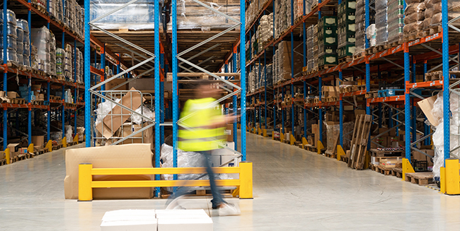 warehouse worker and pallet rack aisles.