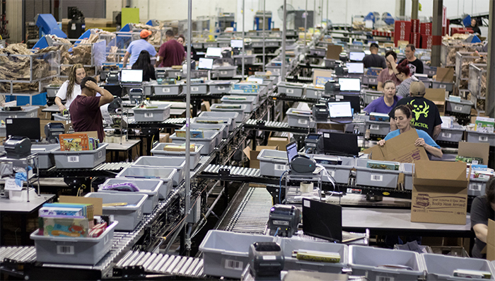 Automated packing area for an ecommerce distribution center, pick-to-totes operation.