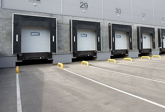 Tuck loading dock with painted guides and guardrails.