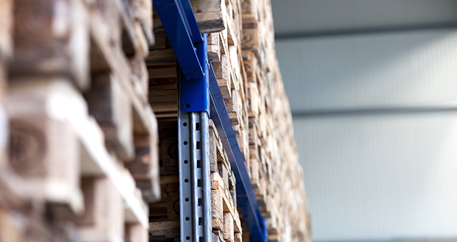 Pallet rack system in a warehouse carrying heavy pallet stacks.