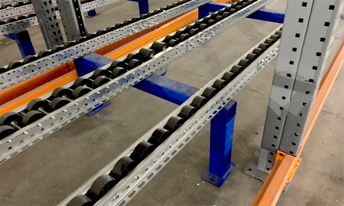 Magnum rollers mounted inside a pallet flow rack frame.