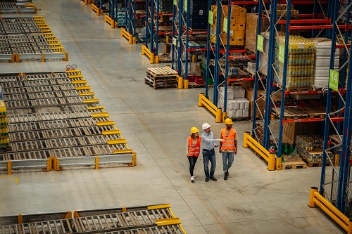 warehouse workers walking and evaluating facility