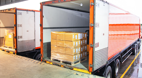 order arriving at a shipping and receiving dock with cartons on a pallet inside a truck trailer.
