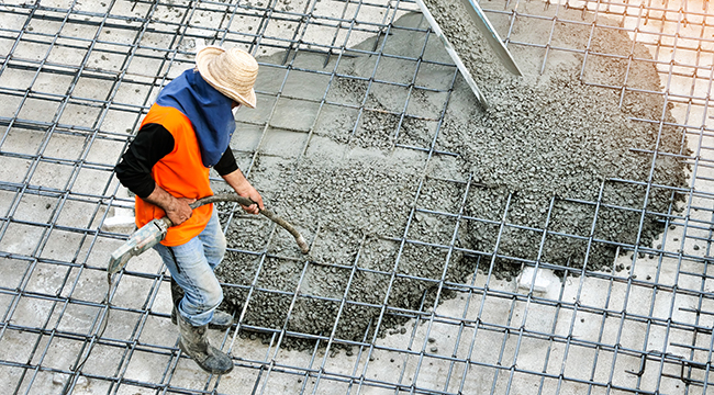 Concrete slab being poured for a warehouse floor.