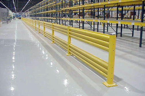 Photo of warehouse with guardrail installed to protect pallet rack.