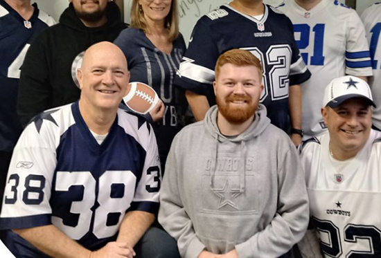 Randy Williams, Cisco-Eagle with fellow employee owners, wearing Dallas Cowboys gear