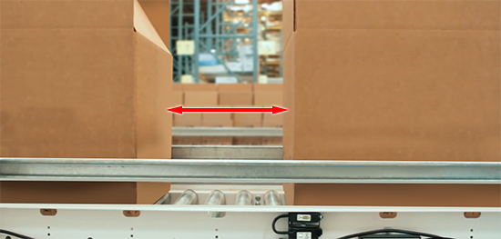Cartons on a zero-pressure conveyor line with defined gaps between them.