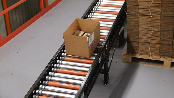 Roller conveyor incline with urethane sleeved rollers in an ecommerce distribution center