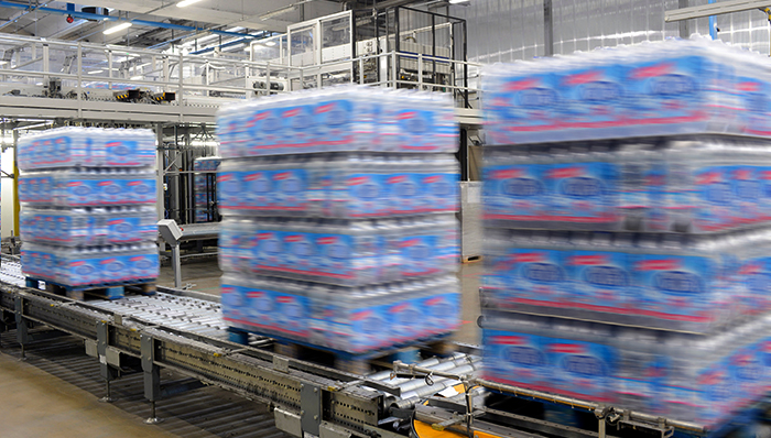 Conveyors moving pallets in a distribution center.