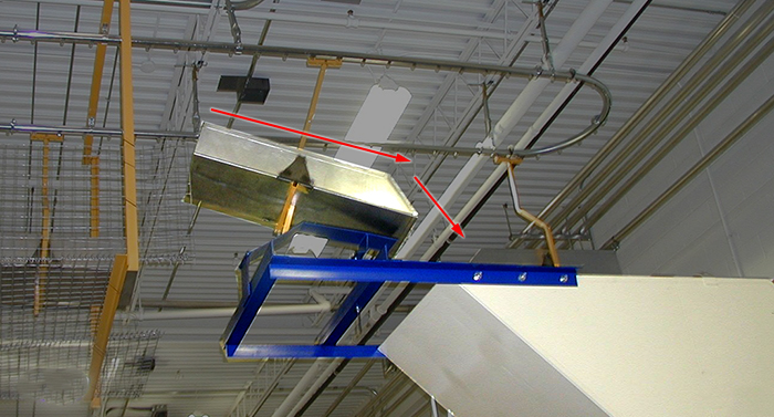 suspended carrier overhead conveyor dumping technique into a trash or recycling hopper