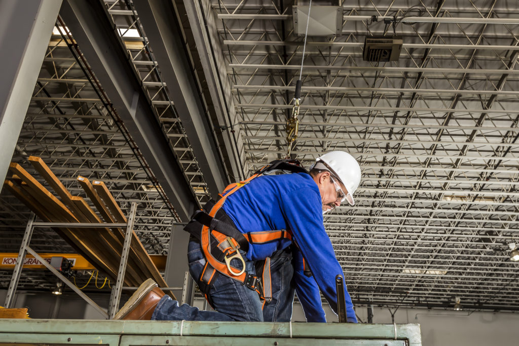 Worker in fall protection harness