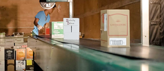 conveying palletized cases to a shipping truck in a distribution center.