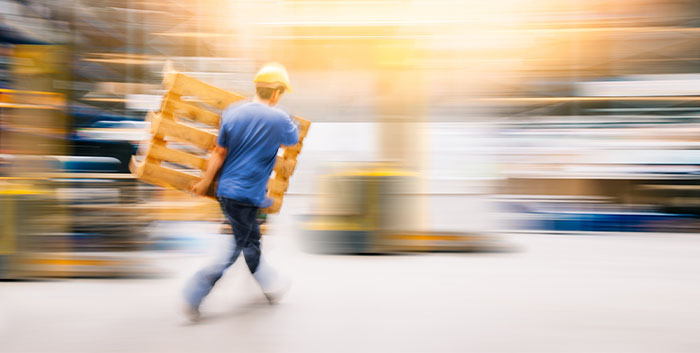 warehouse worker, walking and carrying a pallet
