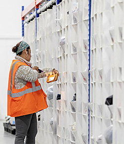 worker using storage cells in warehouse